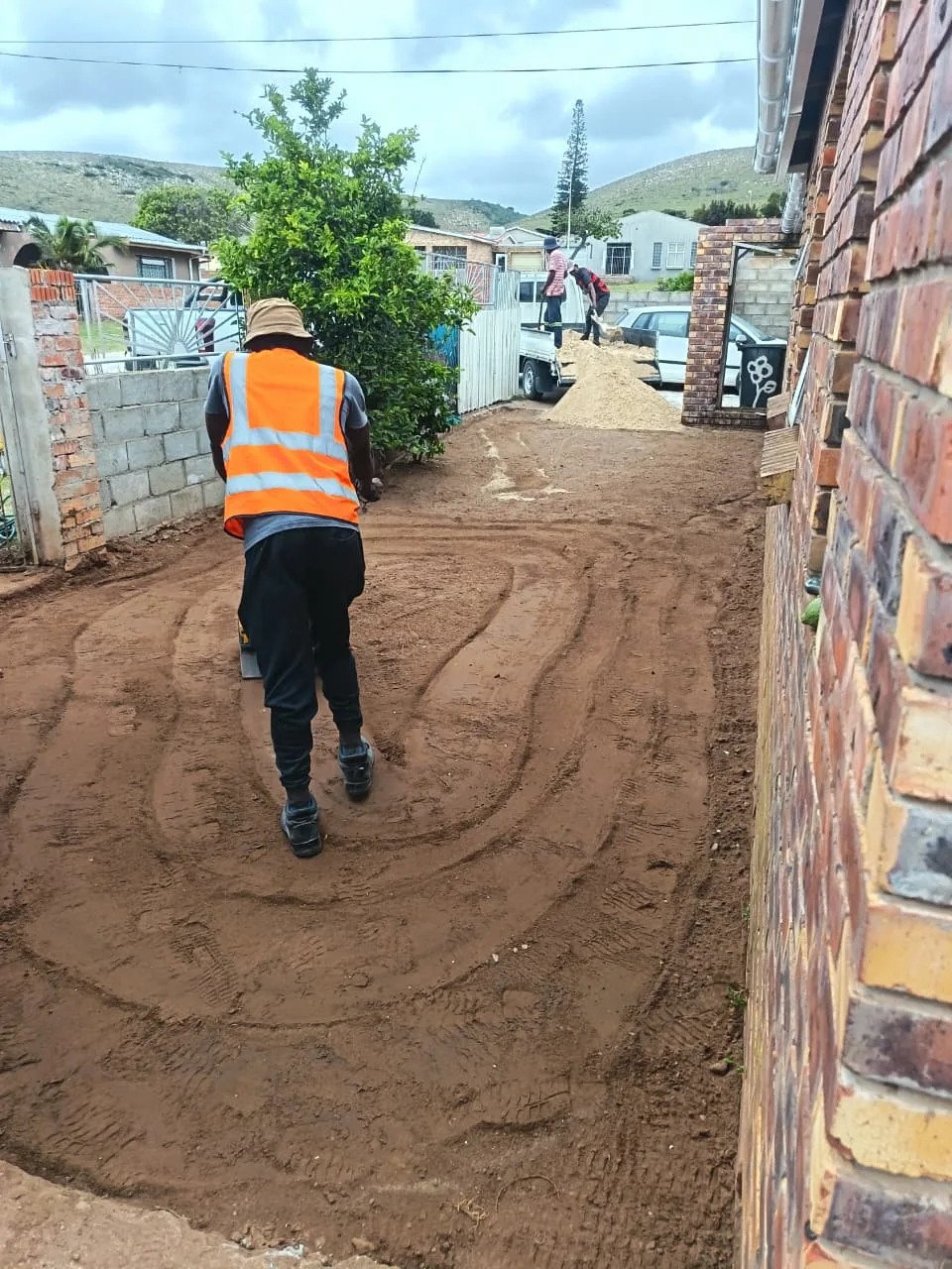 Site preparation team compacting base layer