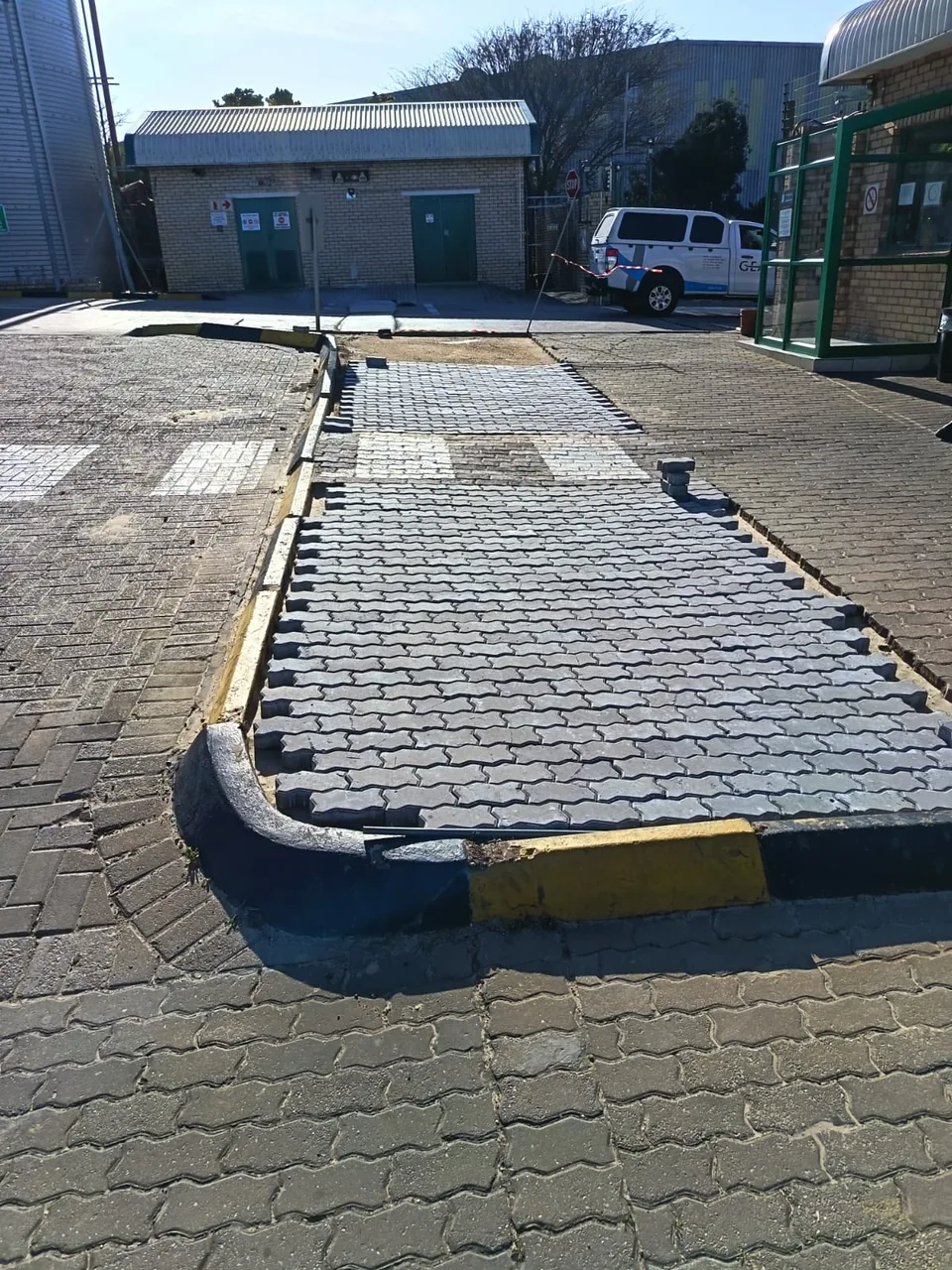 New interlocking pavers keyed into an existing industrial surface during a repair contract