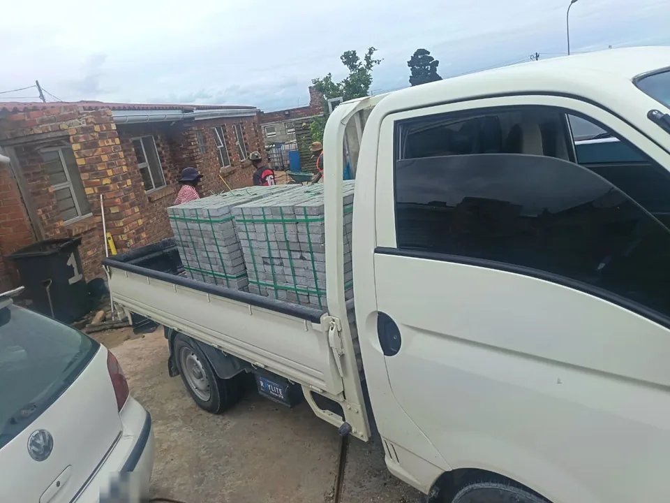 Paver delivery — bakkie loaded with grey pavers