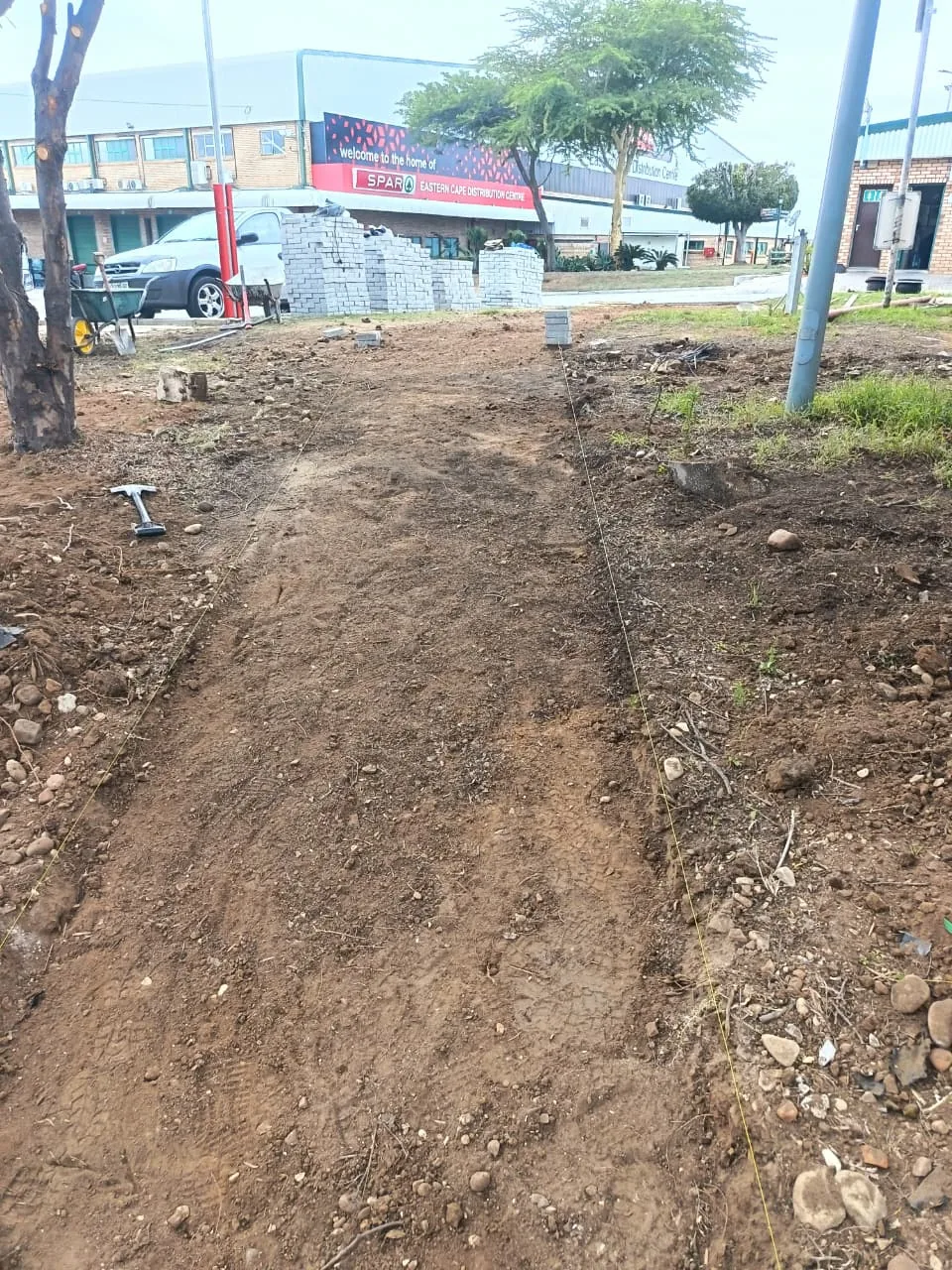 Cleared site with string lines set out before paving at the SPAR site